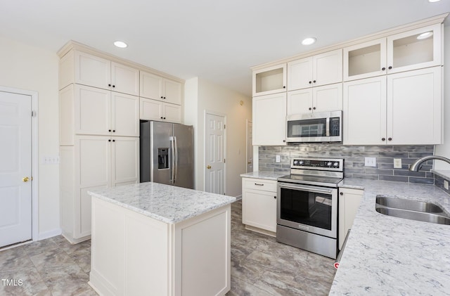 1613 Patterson Grove Rd, Apex, NC 27502 - kitchen featuring appliances with stainless steel finishes, a sink, decorative backsplash, recessed lighting, and glass insert cabinets