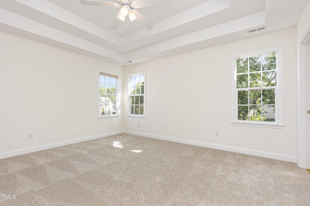 1613 Patterson Grove Rd, Apex, NC 27502 - empty room featuring a tray ceiling, light colored carpet, and baseboards