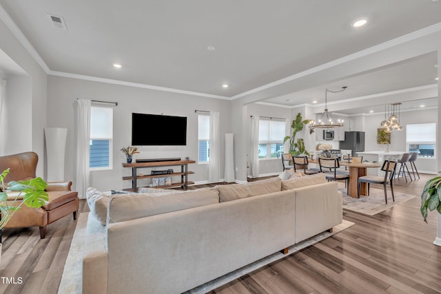 1729 Starlit Sky Ln, Cary, NC 27519 - living room featuring light wood-type flooring, plenty of natural light, a chandelier, recessed lighting, and crown molding