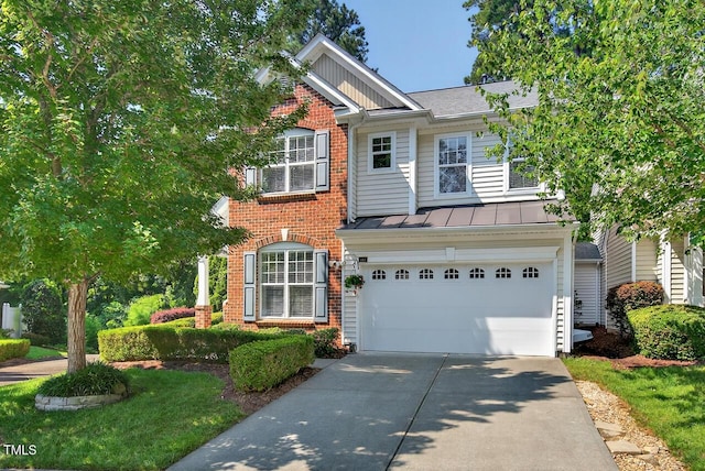 117 Sonoma Way, Chapel Hill, NC 27516 - view of front facade with brick siding, an attached garage, concrete driveway, a standing seam roof, and board and batten siding