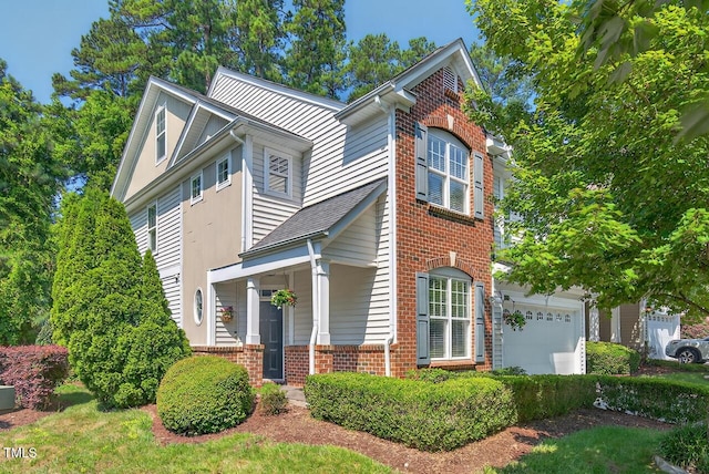 117 Sonoma Way, Chapel Hill, NC 27516 - view of front facade with brick siding, a porch, and a garage
