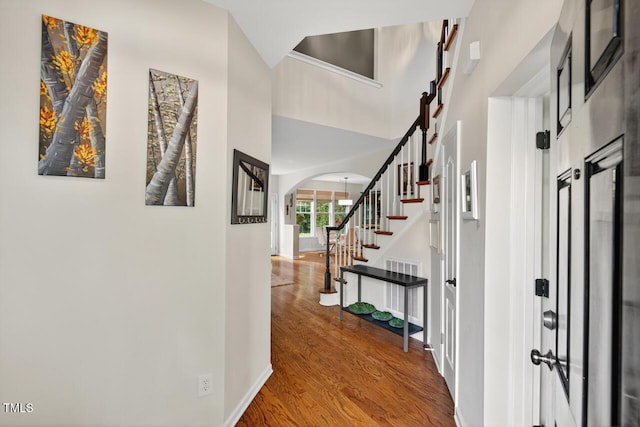 117 Sonoma Way, Chapel Hill, NC 27516 - entryway featuring wood finished floors, arched walkways, stairway, and a towering ceiling