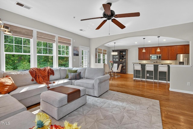 117 Sonoma Way, Chapel Hill, NC 27516 - living area featuring arched walkways, light wood-style floors, ceiling fan, and recessed lighting
