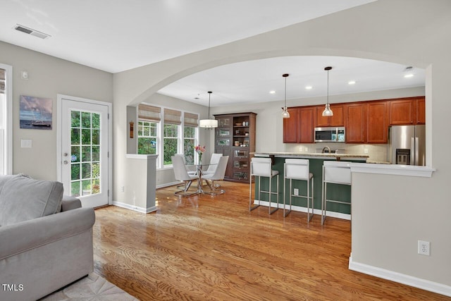 117 Sonoma Way, Chapel Hill, NC 27516 - kitchen featuring appliances with stainless steel finishes, recessed lighting, arched walkways, light countertops, and a breakfast bar area