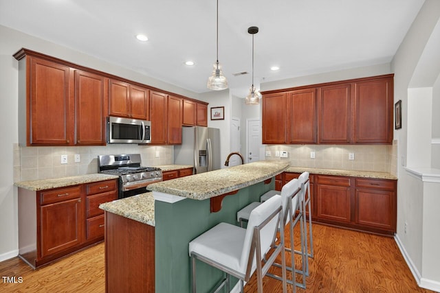 117 Sonoma Way, Chapel Hill, NC 27516 - kitchen featuring appliances with stainless steel finishes, backsplash, light wood-type flooring, a breakfast bar area, and recessed lighting