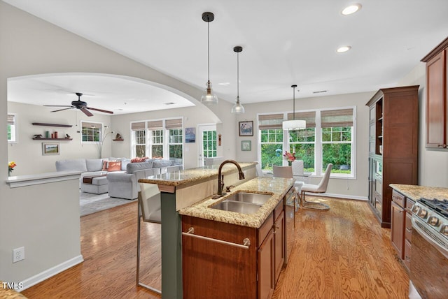 117 Sonoma Way, Chapel Hill, NC 27516 - kitchen featuring arched walkways, light wood finished floors, recessed lighting, a breakfast bar, and ceiling fan