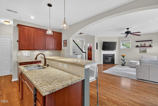 117 Sonoma Way, Chapel Hill, NC 27516 - kitchen featuring a ceiling fan, backsplash, light wood-style floors, arched walkways, and open floor plan