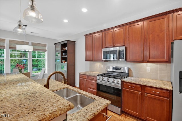 117 Sonoma Way, Chapel Hill, NC 27516 - kitchen featuring stainless steel appliances, recessed lighting, decorative backsplash, light stone countertops, and decorative light fixtures