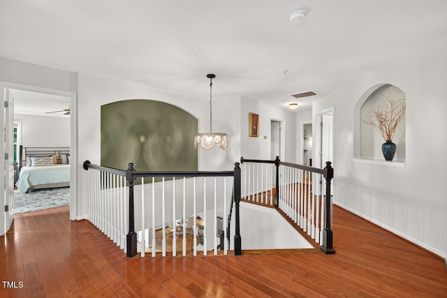 117 Sonoma Way, Chapel Hill, NC 27516 - hall featuring an upstairs landing, a chandelier, and wood-type flooring