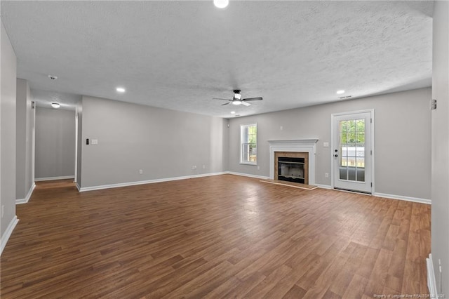 107 Beaumont Ct, Raeford, NC 28376 - unfurnished living room with a ceiling fan, wood finished floors, recessed lighting, baseboards, and a glass covered fireplace