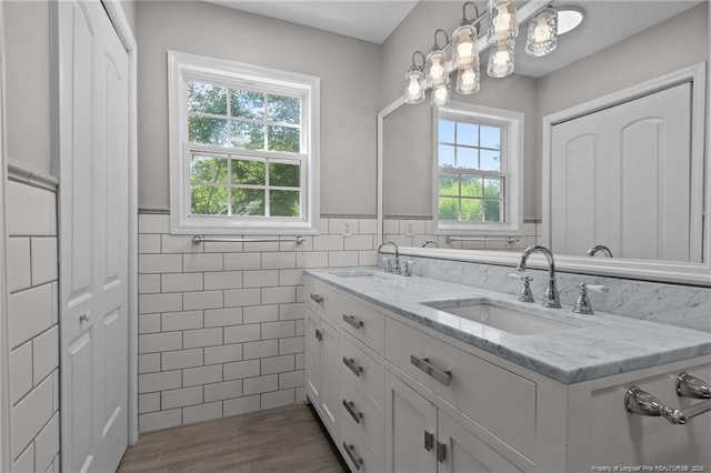 107 Beaumont Ct, Raeford, NC 28376 - full bath featuring healthy amount of natural light, tile walls, double vanity, a wainscoted wall, and a chandelier
