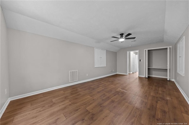 107 Beaumont Ct, Raeford, NC 28376 - unfurnished bedroom featuring dark wood-style flooring, baseboards, lofted ceiling, and ceiling fan