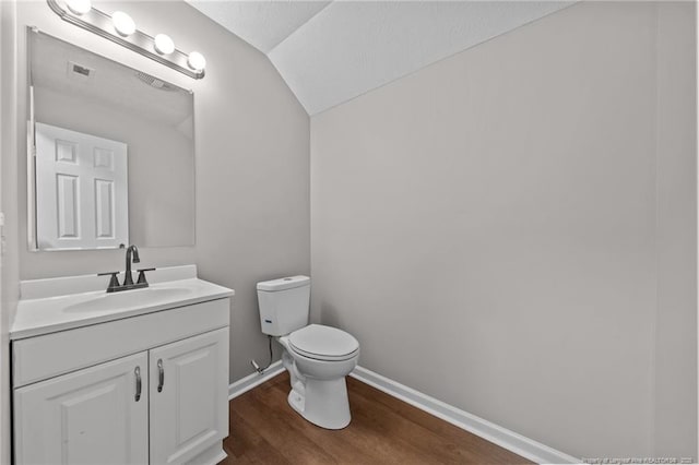 107 Beaumont Ct, Raeford, NC 28376 - bathroom featuring toilet, vanity, wood finished floors, vaulted ceiling, and baseboards
