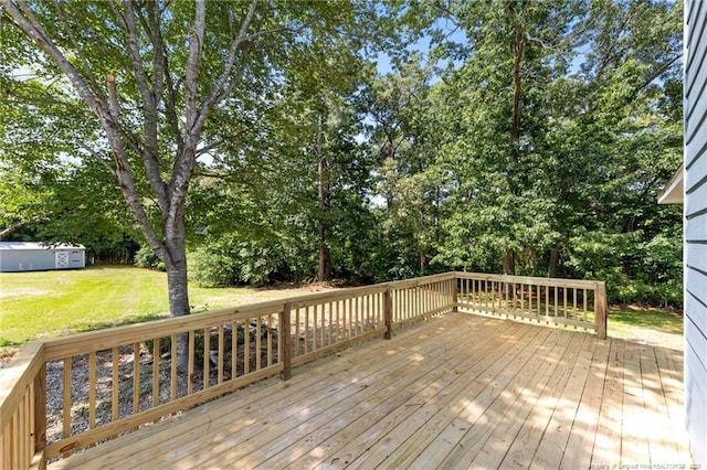 107 Beaumont Ct, Raeford, NC 28376 - wooden terrace with a yard, an outdoor structure, and view of scattered trees