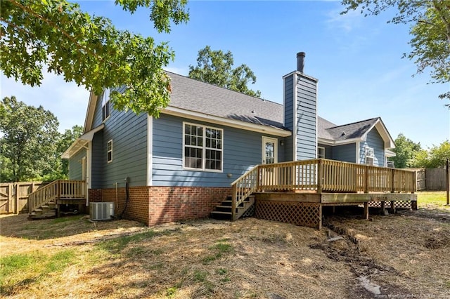 107 Beaumont Ct, Raeford, NC 28376 - back of property with central air condition unit, a wooden deck, brick siding, a chimney, and stairs