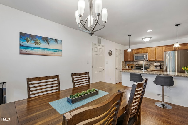 131 Abacos Ct, Clayton, NC 27520 - dining area with a chandelier and wood finished floors