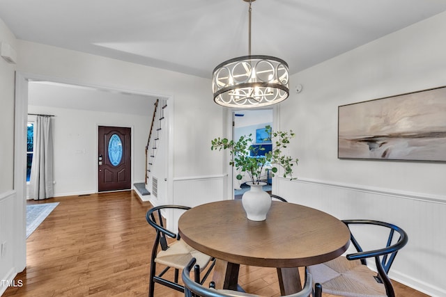 8 Great Oak Ct, Durham, NC 27713 - dining area with a chandelier, a wainscoted wall, wood finished floors, and stairway