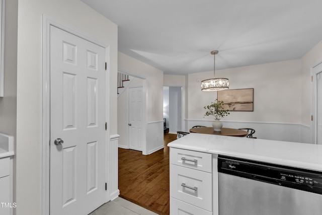 8 Great Oak Ct, Durham, NC 27713 - kitchen with stainless steel dishwasher, light countertops, white cabinetry, a chandelier, and pendant lighting