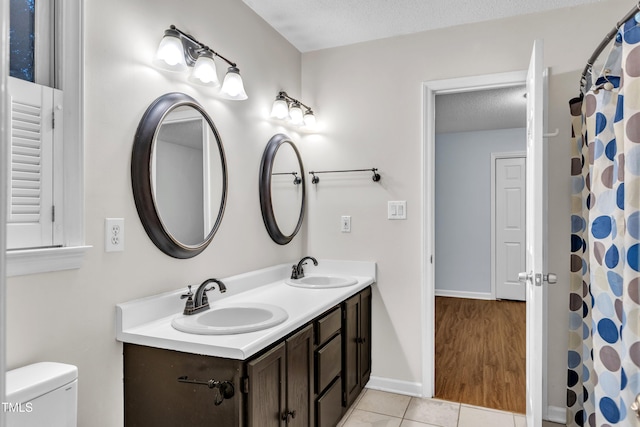 8 Great Oak Ct, Durham, NC 27713 - bathroom featuring double vanity, tile patterned floors, and a textured ceiling