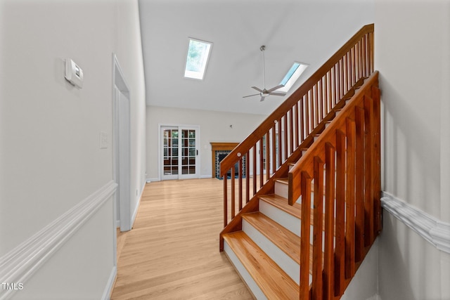 6008 Chittim Ct, Raleigh, NC 27616 - stairs with a skylight, wood finished floors, high vaulted ceiling, and baseboards