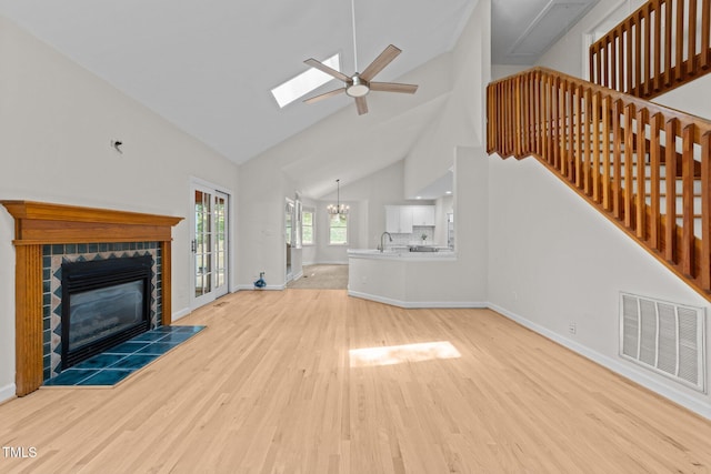 6008 Chittim Ct, Raleigh, NC 27616 - unfurnished living room with wood finished floors, high vaulted ceiling, a sink, a fireplace, and a ceiling fan