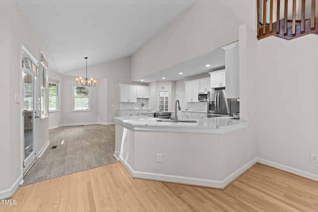 6008 Chittim Ct, Raleigh, NC 27616 - kitchen featuring stainless steel appliances, a chandelier, a sink, light wood-type flooring, and light countertops