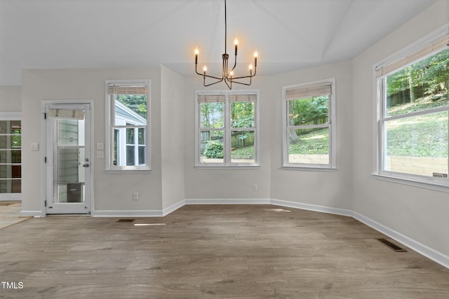 6008 Chittim Ct, Raleigh, NC 27616 - unfurnished dining area with a chandelier, plenty of natural light, wood finished floors, and baseboards