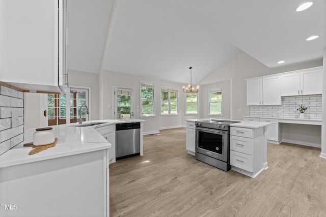 6008 Chittim Ct, Raleigh, NC 27616 - kitchen featuring stainless steel appliances, a sink, light wood finished floors, lofted ceiling, and white cabinets