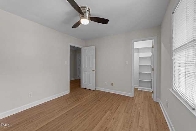 6008 Chittim Ct, Raleigh, NC 27616 - unfurnished bedroom with light wood-style floors, a walk in closet, baseboards, a closet, and a ceiling fan