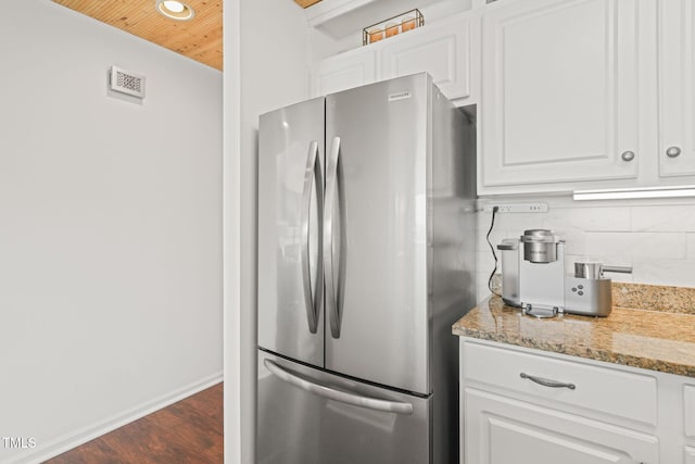 65 The Moorings Unit 65, Clarksville, VA 23927 - kitchen with freestanding refrigerator, wooden ceiling, white cabinets, dark wood-type flooring, and tasteful backsplash