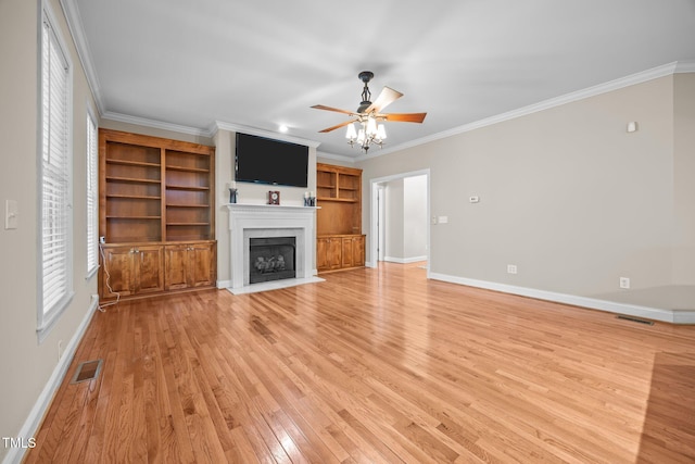 44 Supreme Dr, Lillington, NC 27546 - unfurnished living room featuring a fireplace with flush hearth, ceiling fan, light wood-style flooring, and ornamental molding