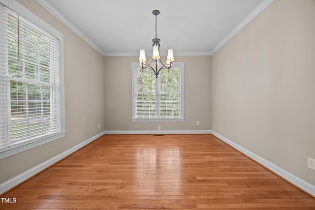 44 Supreme Dr, Lillington, NC 27546 - empty room featuring a chandelier, healthy amount of natural light, light wood-type flooring, and crown molding