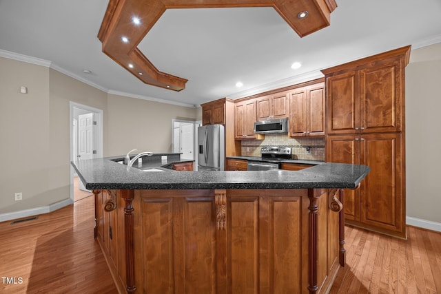 44 Supreme Dr, Lillington, NC 27546 - kitchen featuring appliances with stainless steel finishes, light wood-style floors, a spacious island, backsplash, and a kitchen breakfast bar