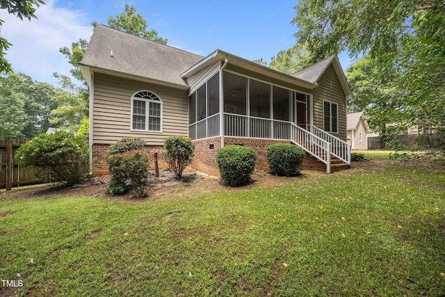 44 Supreme Dr, Lillington, NC 27546 - back of property with a sunroom, brick siding, and a shingled roof