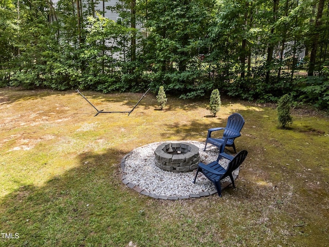 45 Chaucer Ct W, Zebulon, NC 27597 - view of grassy yard featuring an outdoor fire pit