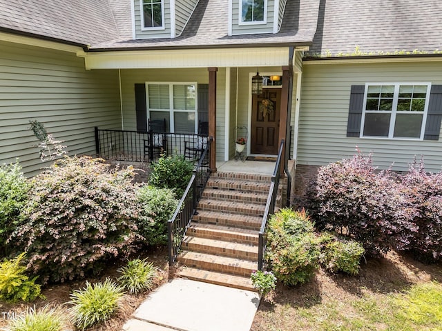 45 Chaucer Ct W, Zebulon, NC 27597 - property entrance featuring covered porch and roof with shingles