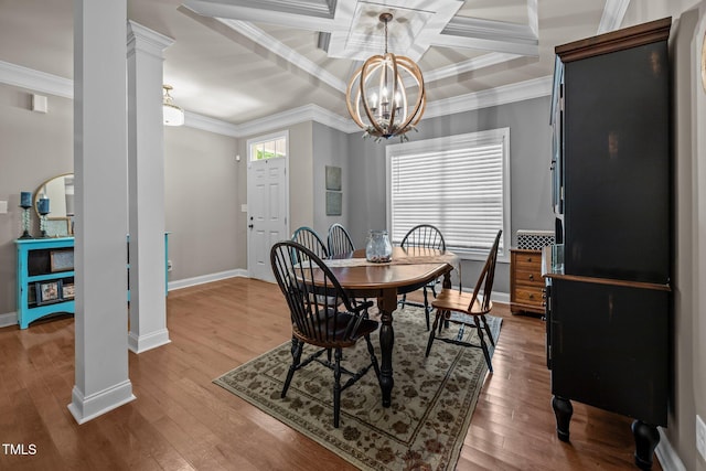 45 Chaucer Ct W, Zebulon, NC 27597 - dining area with decorative columns, crown molding, a chandelier, baseboards, and wood finished floors
