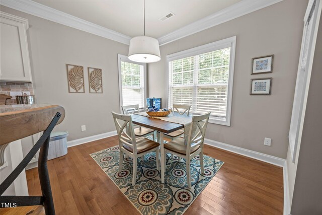 45 Chaucer Ct W, Zebulon, NC 27597 - dining space with crown molding, wood finished floors, and baseboards