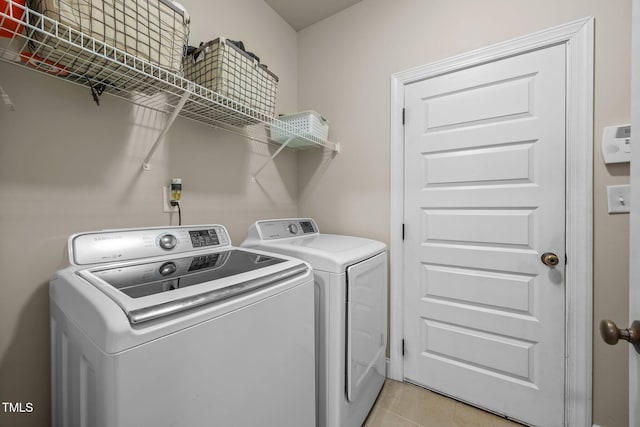 45 Chaucer Ct W, Zebulon, NC 27597 - washroom with washer and dryer and light tile patterned floors