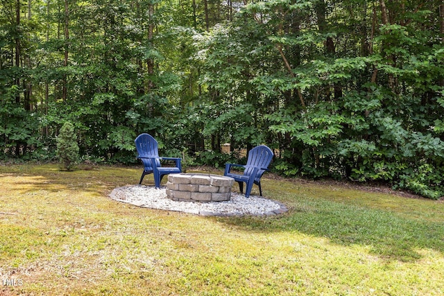 45 Chaucer Ct W, Zebulon, NC 27597 - view of grassy yard featuring an outdoor fire pit