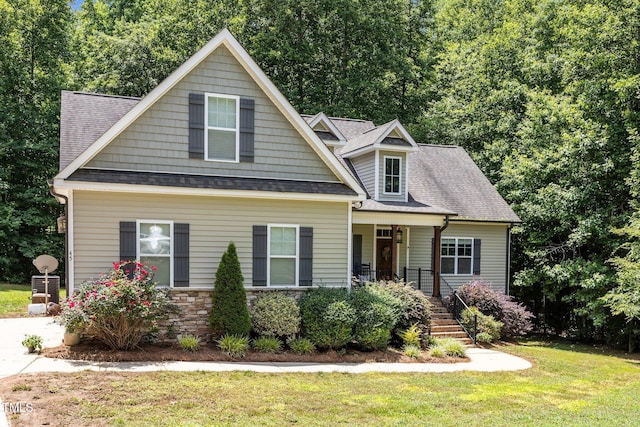 45 Chaucer Ct W, Zebulon, NC 27597 - view of front of property with a porch, a front yard, and a shingled roof