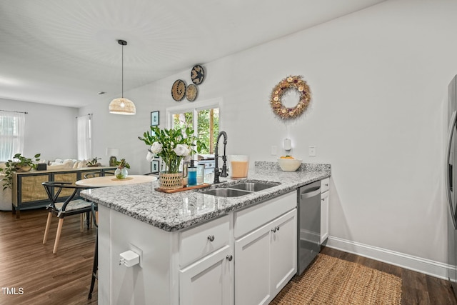 947 Weatherby Ln, Creedmoor, NC 27522 - kitchen with stainless steel dishwasher, a peninsula, white cabinets, dark wood-style floors, and light stone counters
