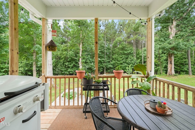 947 Weatherby Ln, Creedmoor, NC 27522 - wooden deck with grilling area, outdoor dining space, and view of wooded area