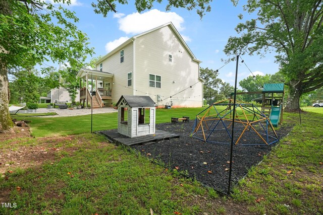 947 Weatherby Ln, Creedmoor, NC 27522 - back of house featuring a playground, a yard, and stairs