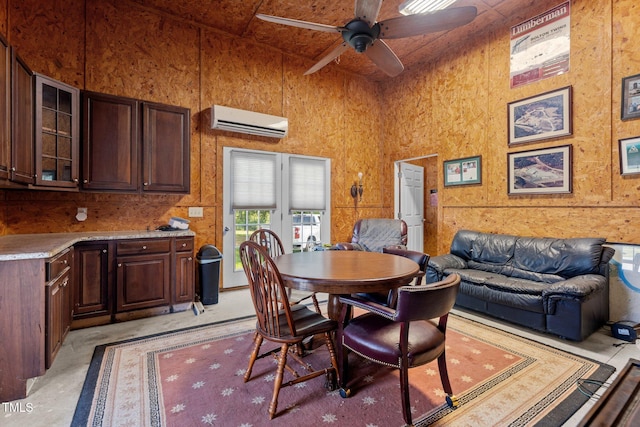 975 Paschall Rd, Warrenton, NC 27589 - dining room with a wall unit AC, concrete floors, a ceiling fan, and a towering ceiling