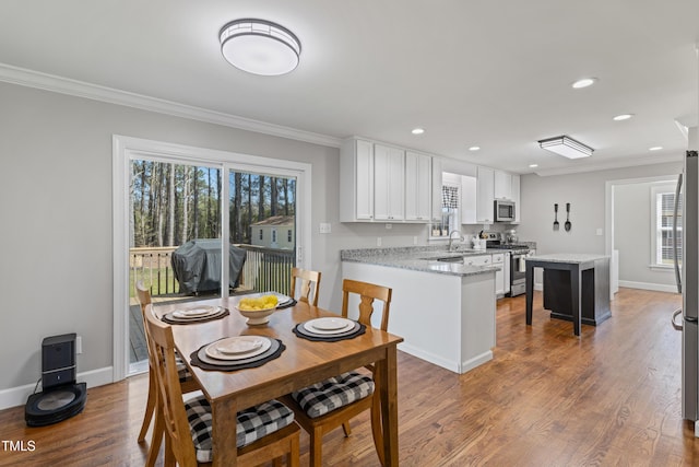317 Hunters Creek Dr, Goldsboro, NC 27534 - dining room with ornamental molding, recessed lighting, wood finished floors, and baseboards