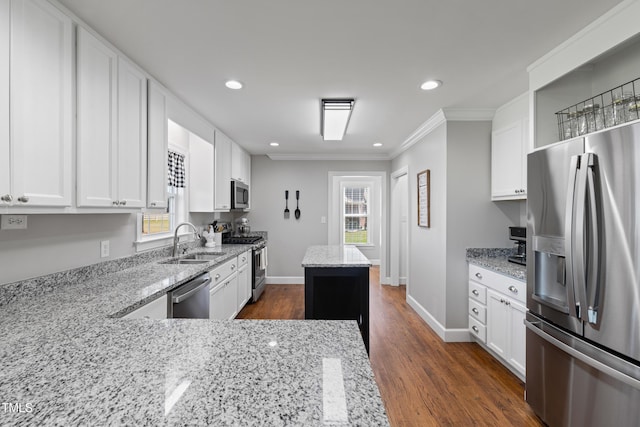 317 Hunters Creek Dr, Goldsboro, NC 27534 - kitchen with stainless steel appliances, a sink, ornamental molding, light stone counters, and white cabinetry