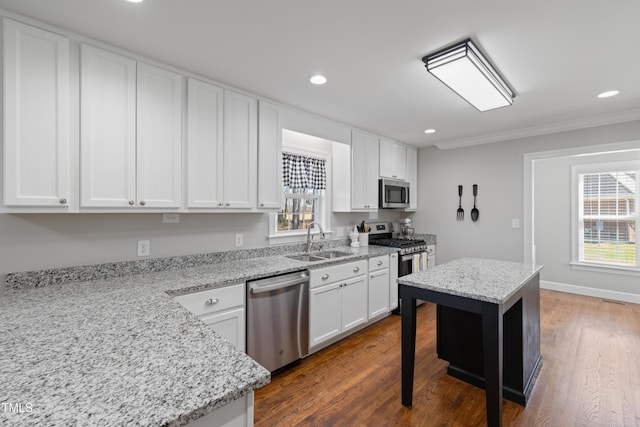 317 Hunters Creek Dr, Goldsboro, NC 27534 - kitchen featuring appliances with stainless steel finishes, a sink, white cabinets, recessed lighting, and ornamental molding