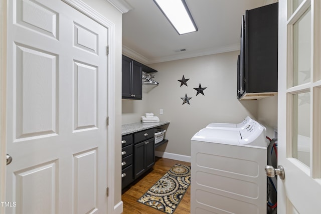 317 Hunters Creek Dr, Goldsboro, NC 27534 - laundry area with cabinet space, crown molding, wood finished floors, independent washer and dryer, and baseboards