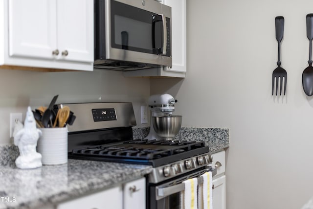 317 Hunters Creek Dr, Goldsboro, NC 27534 - kitchen featuring stainless steel appliances, white cabinets, and light stone countertops